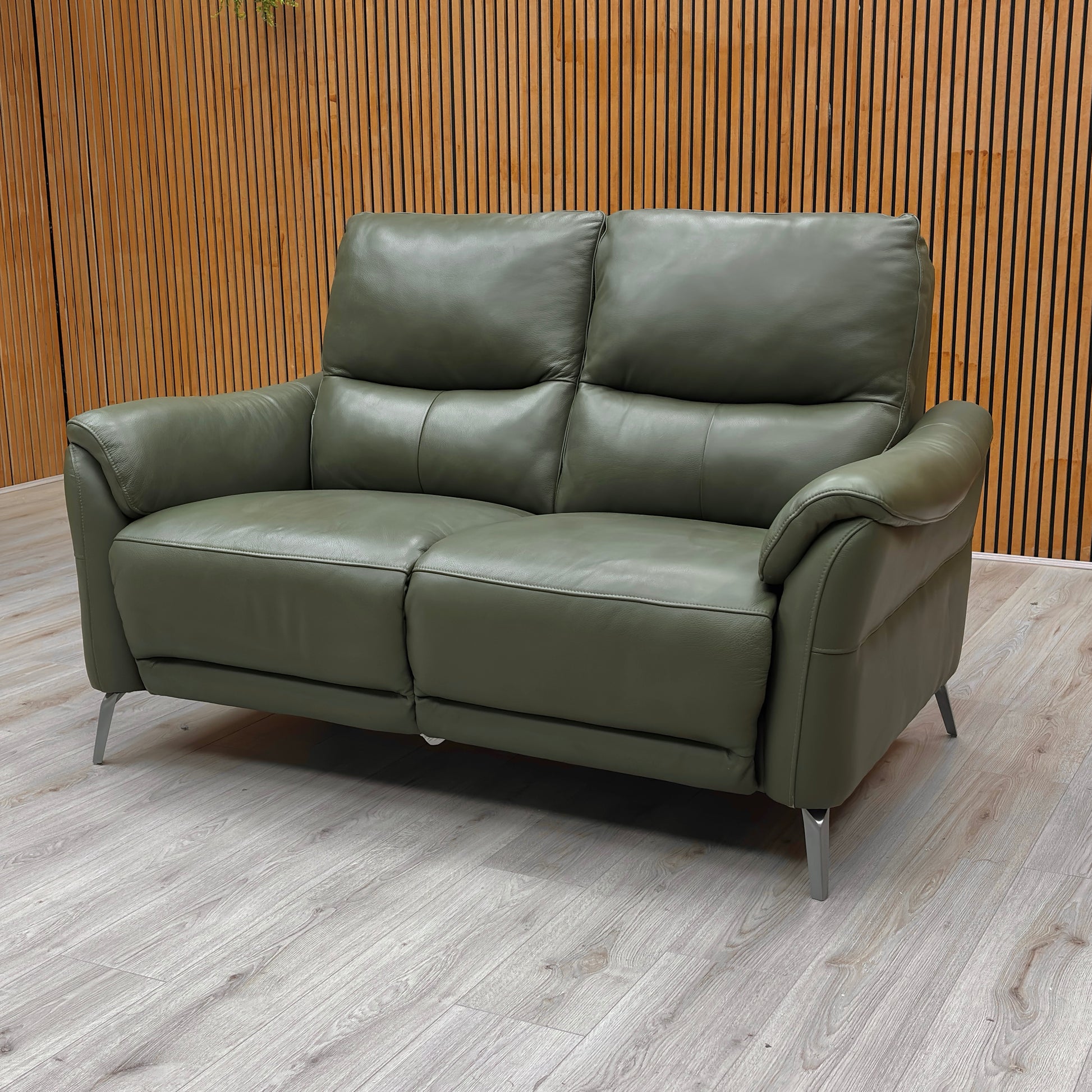 Side view of the 'Daytona' Oslo Pine Green Leather 2 Seater Sofa in a partially reclined position, illustrating the extended footrest and comfortable seating angle.