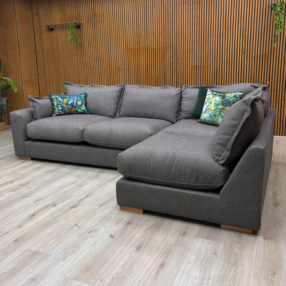 detail of the charcoal grey tight weave fabric on the 'Gaia' sofa, showing the texture and modern feel of the upholstery.